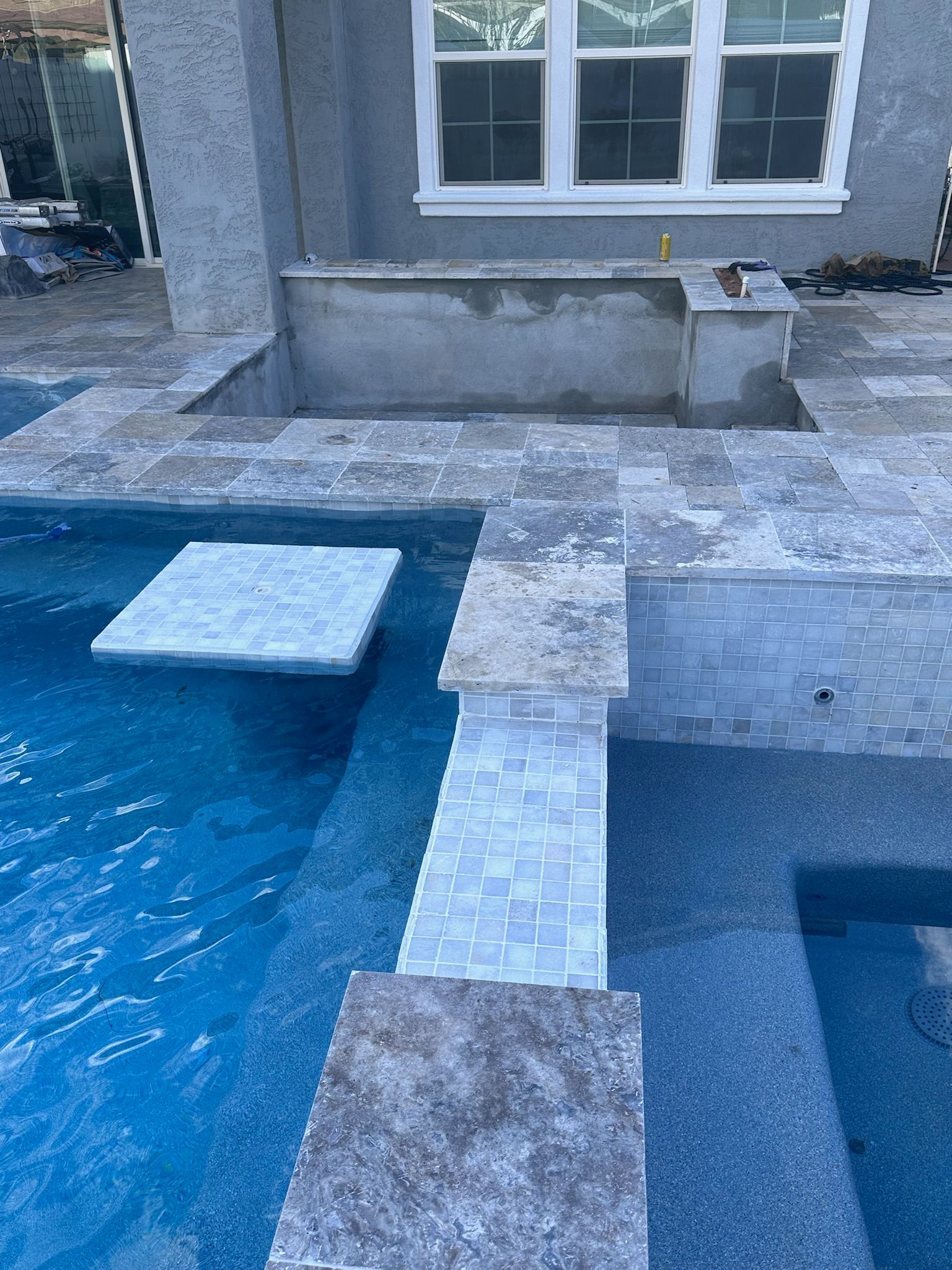 Outdoor living space with patio and pool features